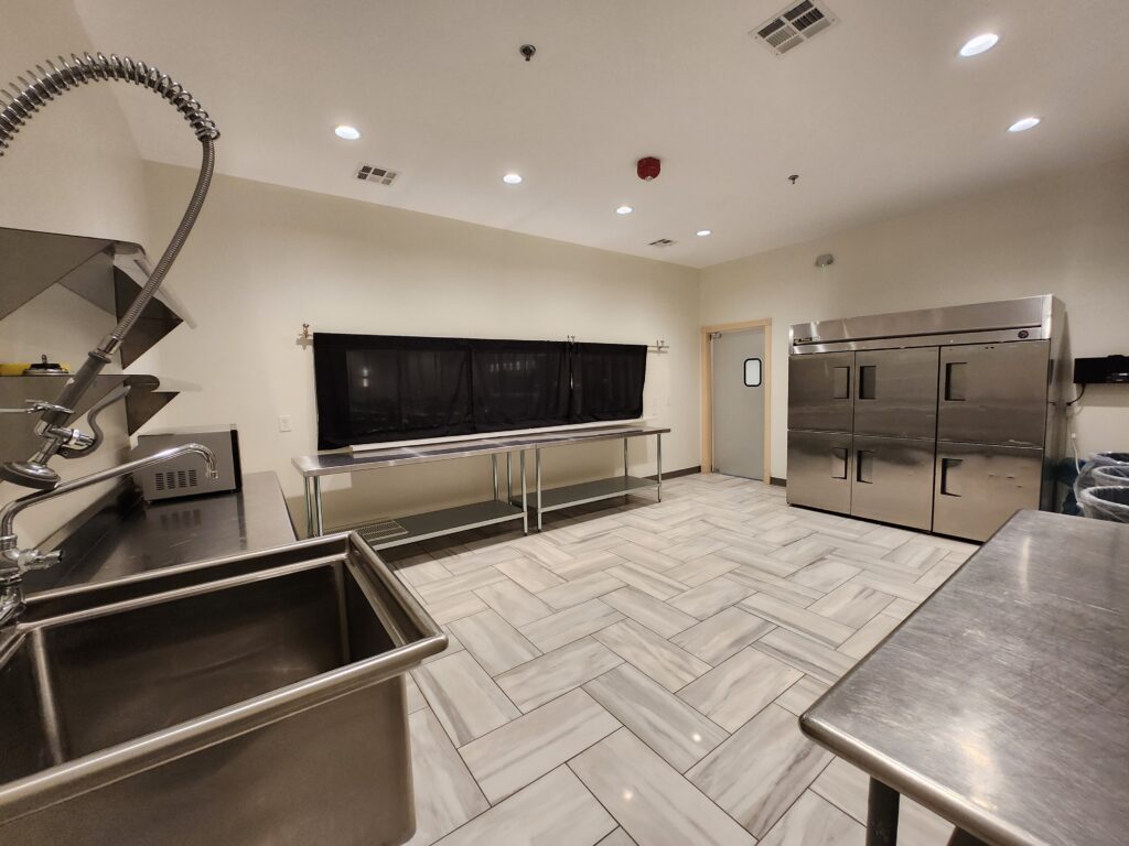 Prep Kitchen Equipped With Ice Machines, Commercial Grade Large Stainless Steel Refrigerators, Stainless Steel Shelves & Tables, Commercial Grade Dishwashing Sink With Extendable Spray Nozzle for easy Cleaning, Tile Floors with inlaid Drainage System.