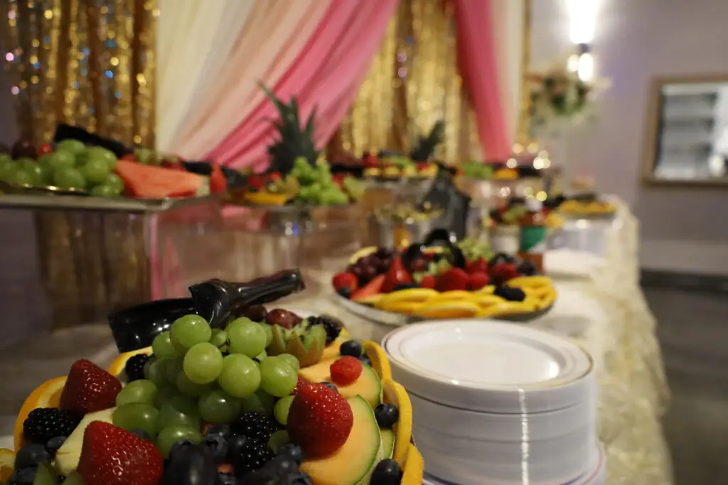 Elegant fruit and dessert table with an array of fresh fruits, pastries, and sweet treats, beautifully arranged for events and celebrations