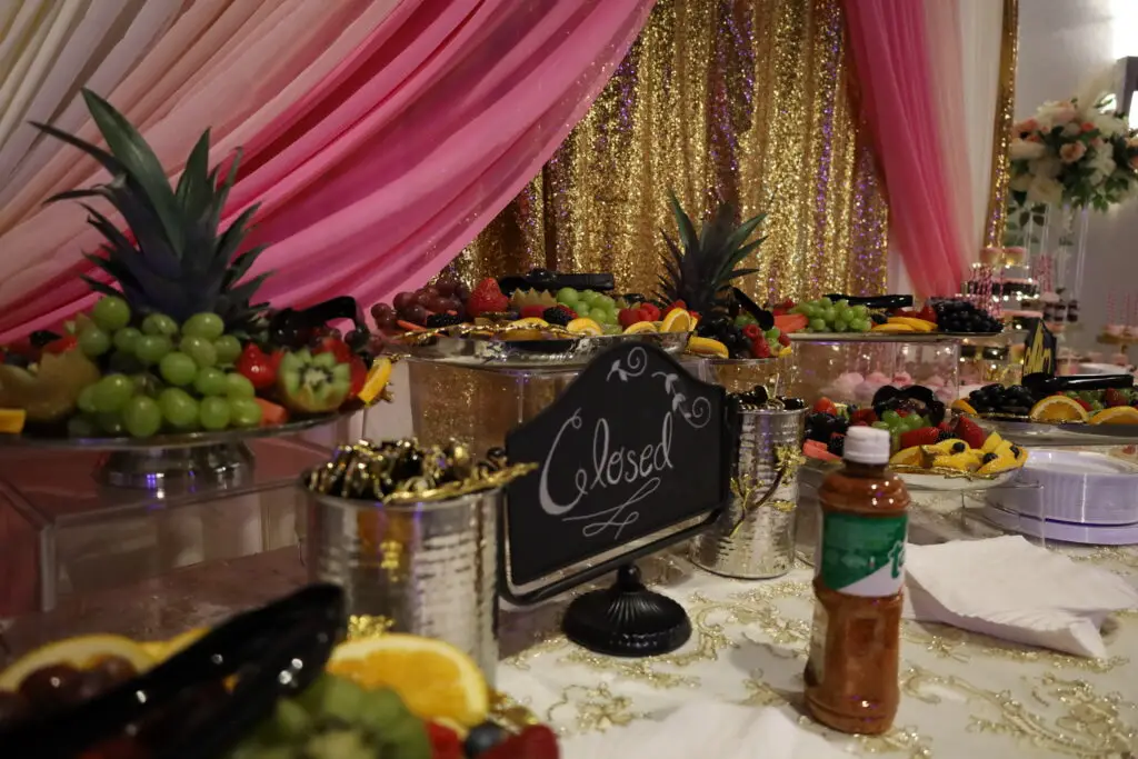 Elegant fruit and dessert table with an array of fresh fruits, pastries, and sweet treats, beautifully arranged for events and celebrations